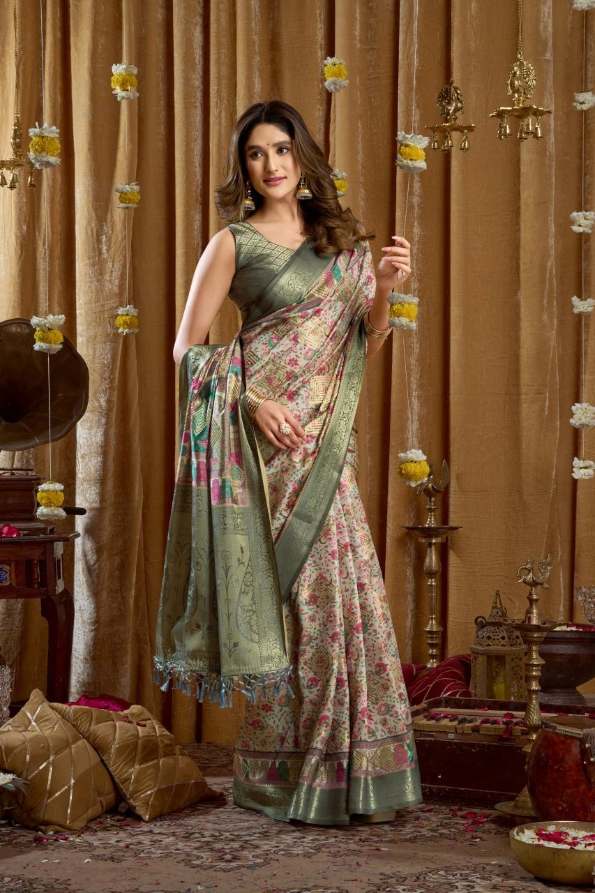Woman in a floral saree standing in a decorated room with traditional decor.